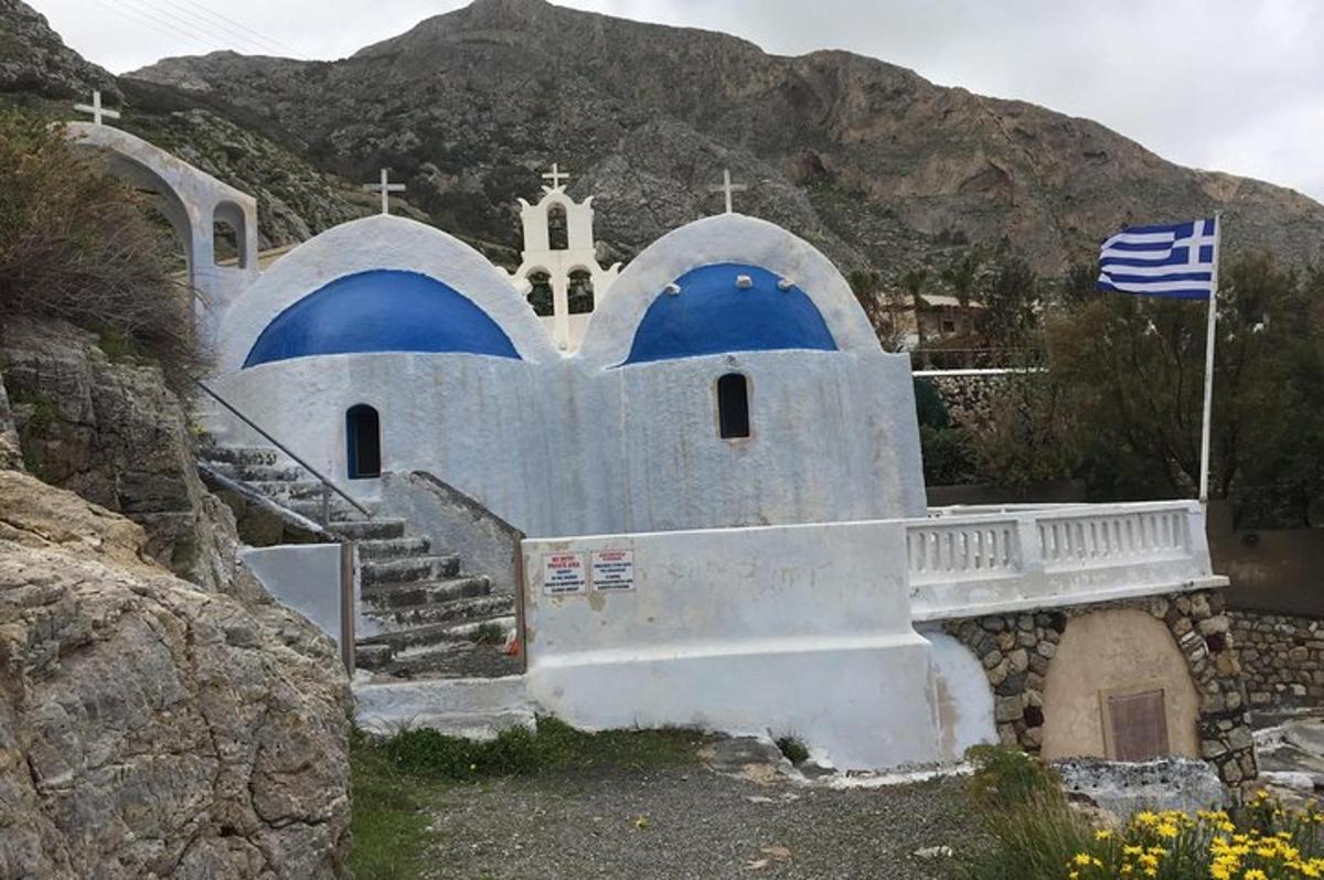 una chiesa bianca con cupole blu e una bandiera