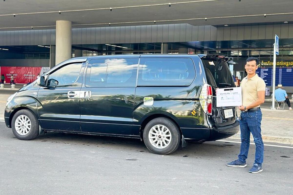 a man is standing next to a black van