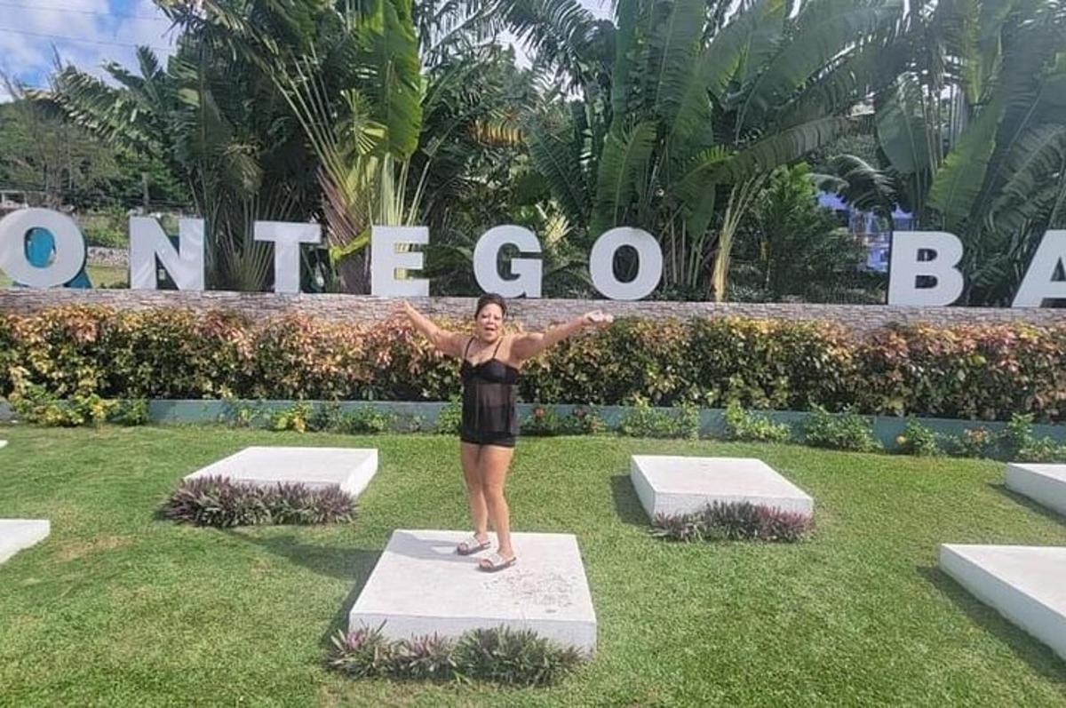 a woman standing on a block in the grass