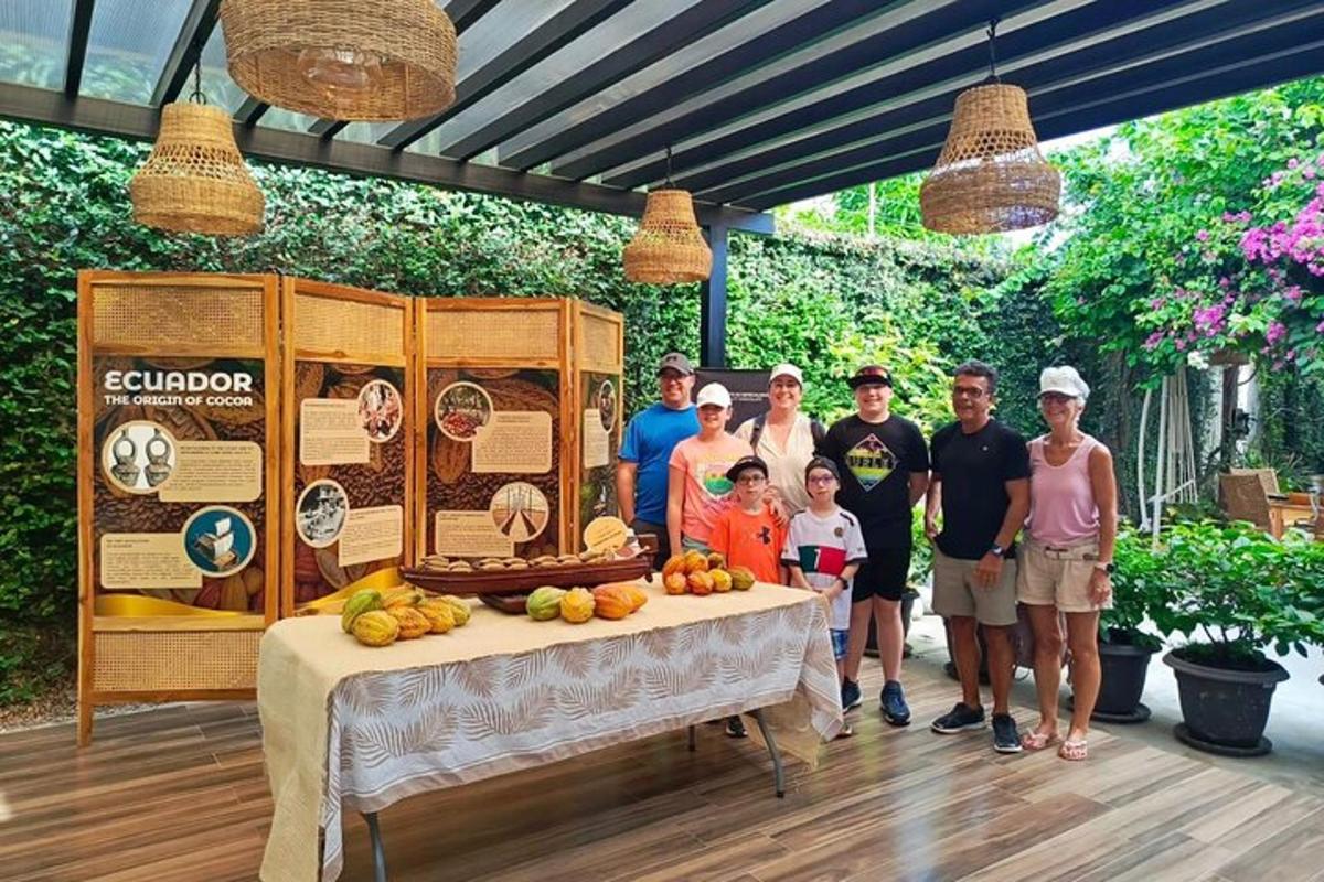 a group of people standing next to a table with fruit