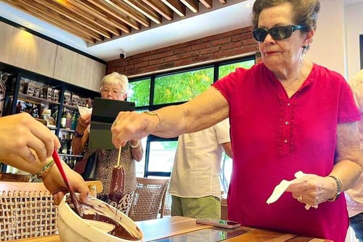 an older woman cutting a banana in a restaurant