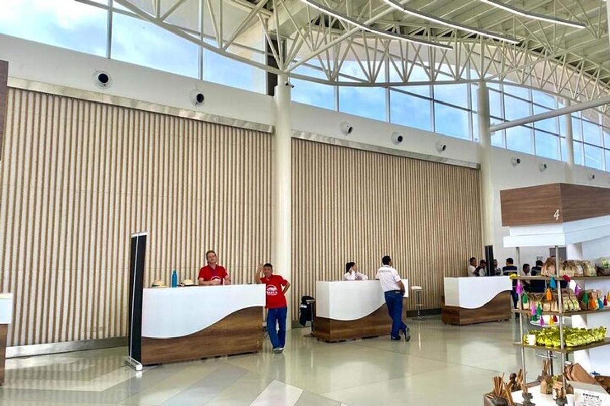 a lobby with people standing at tables in a building