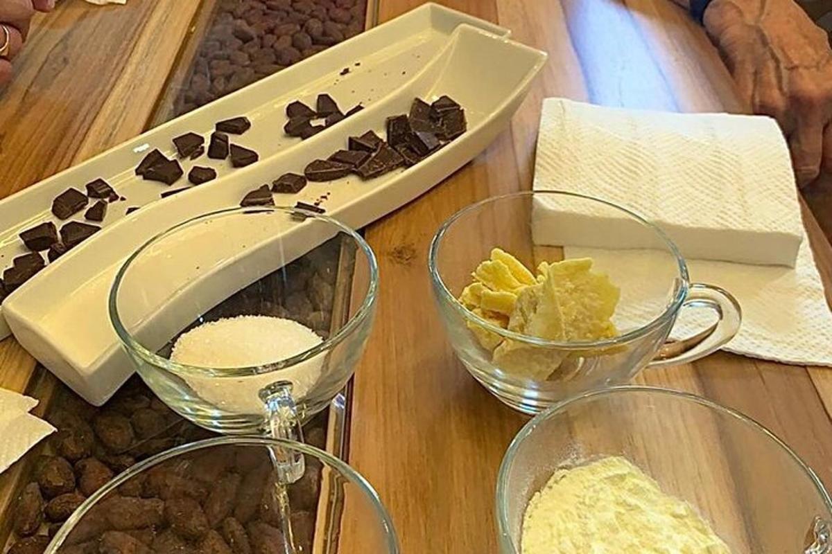 a table with two glasses and a box of chocolate