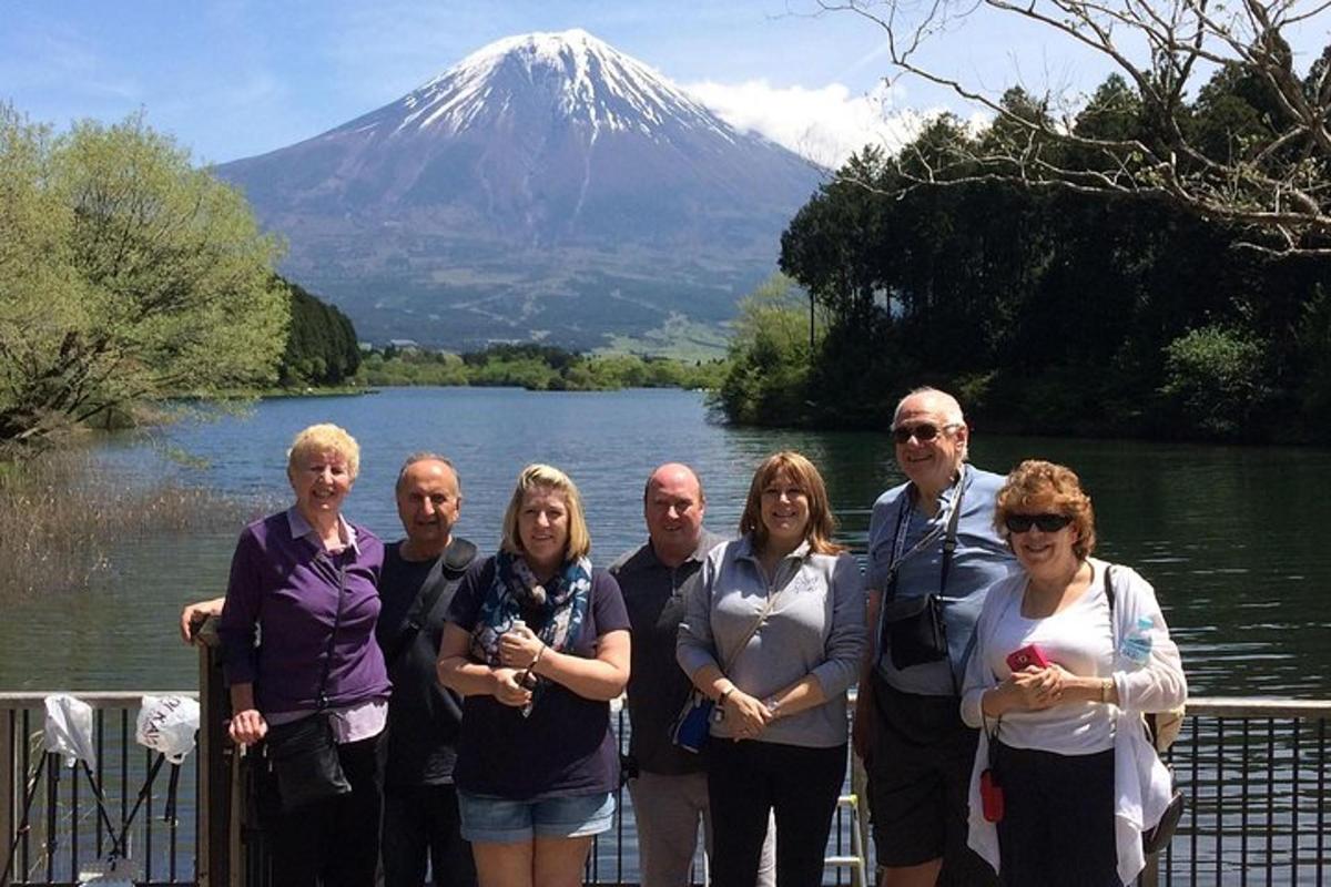 a group of people standing in front of a mountain