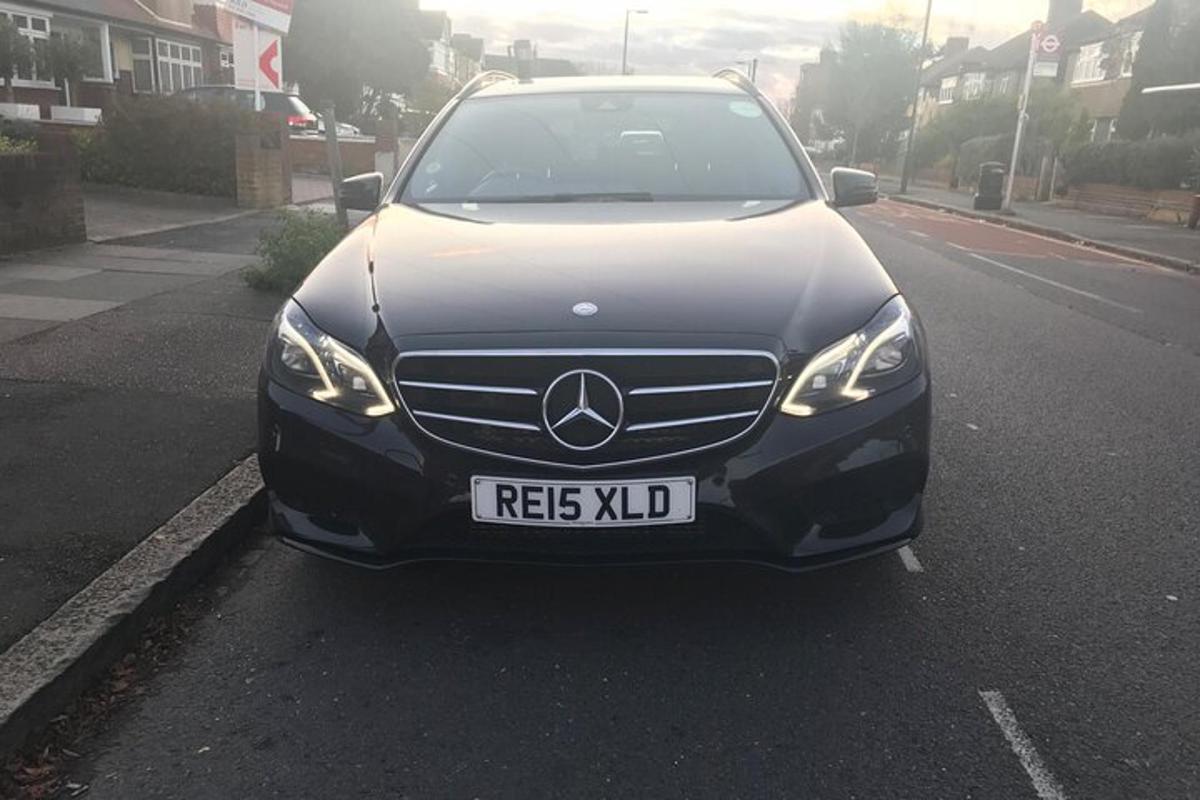 a black car parked on the side of a street