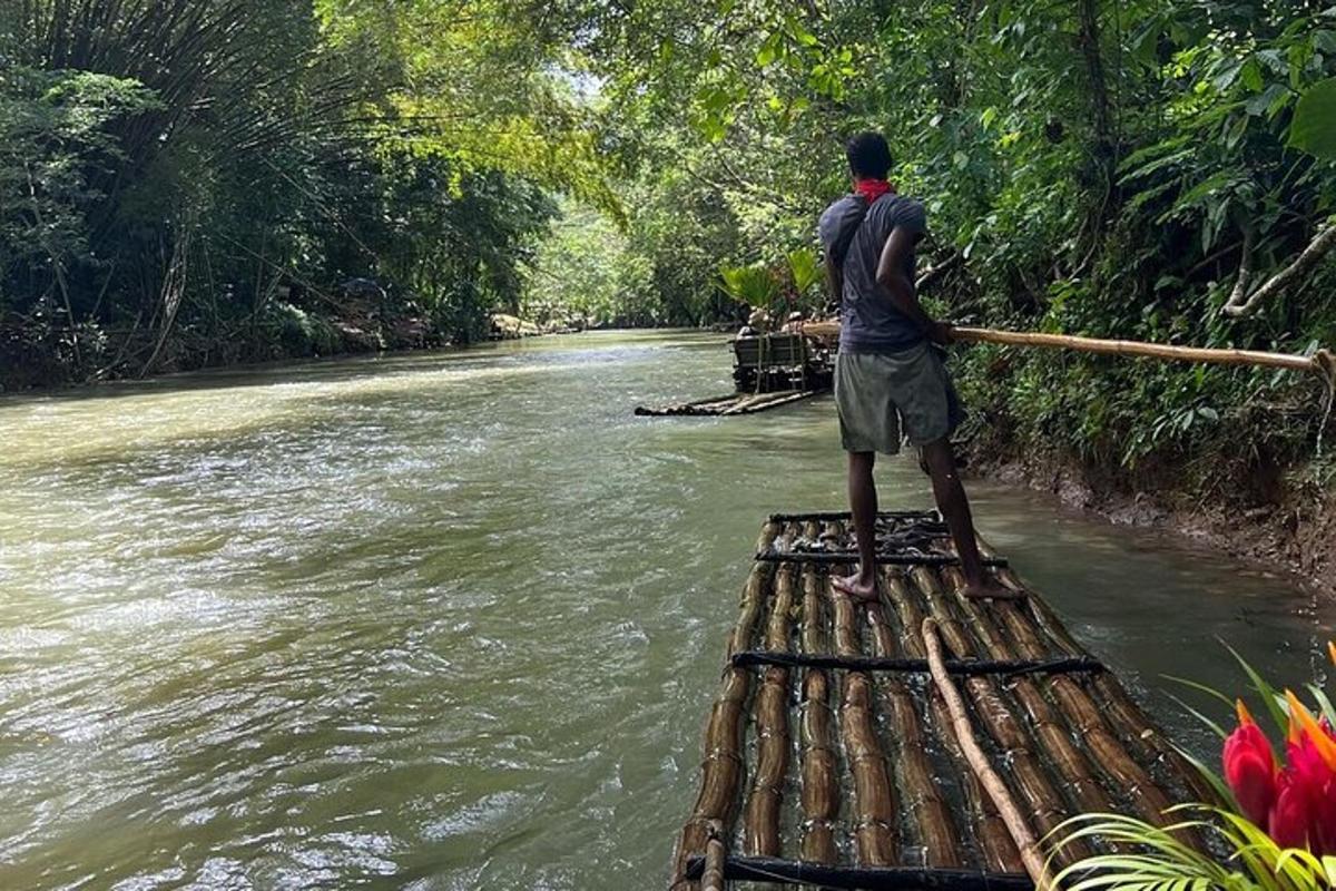 a man standing on the back of a raft in a river