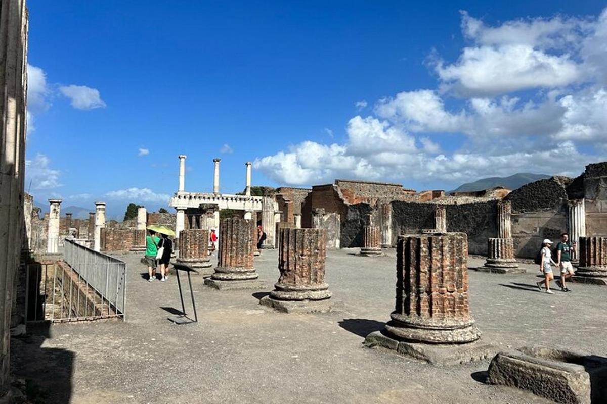 a group of people walking around an ancient ruins