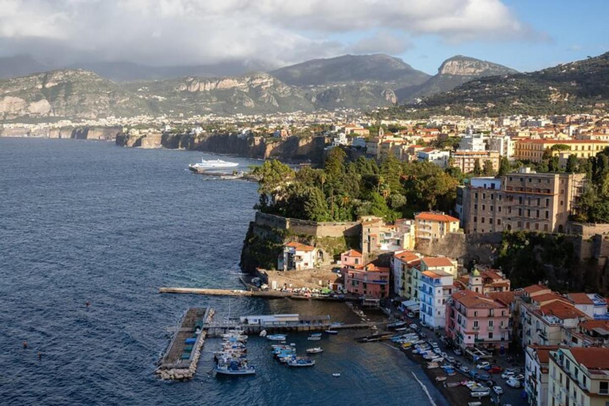 an aerial view of a city with boats in the water