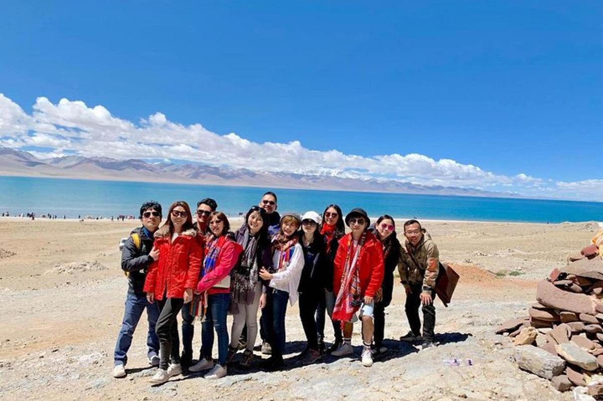 a group of people posing for a picture on the beach