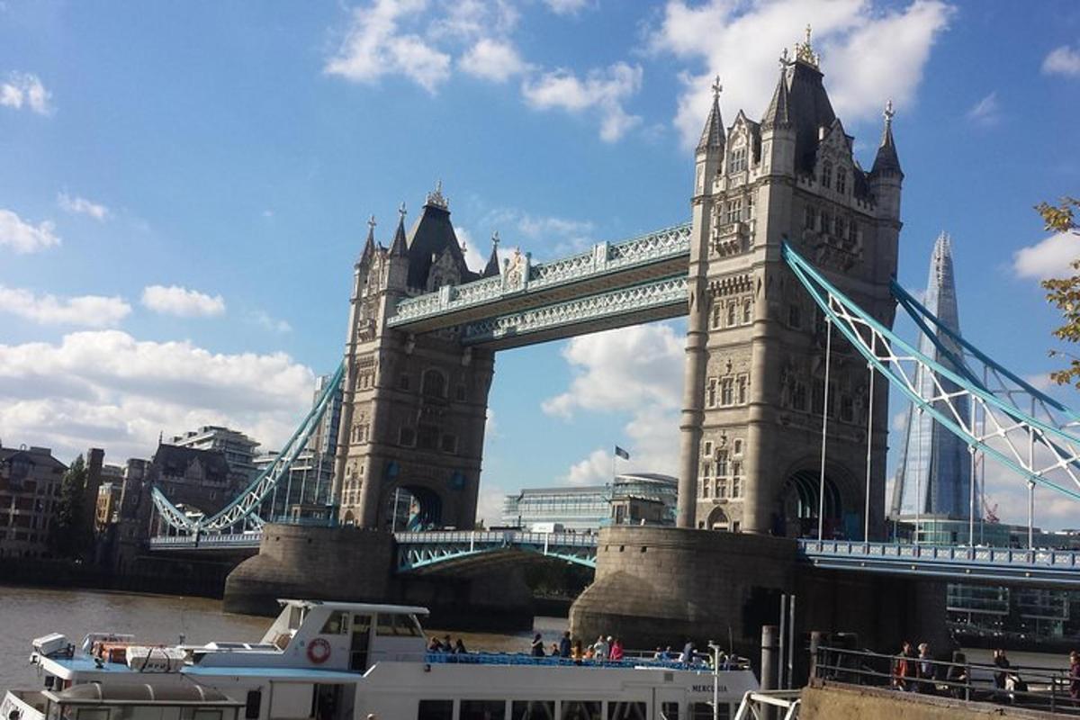 a suspension bridge with a boat in front of it
