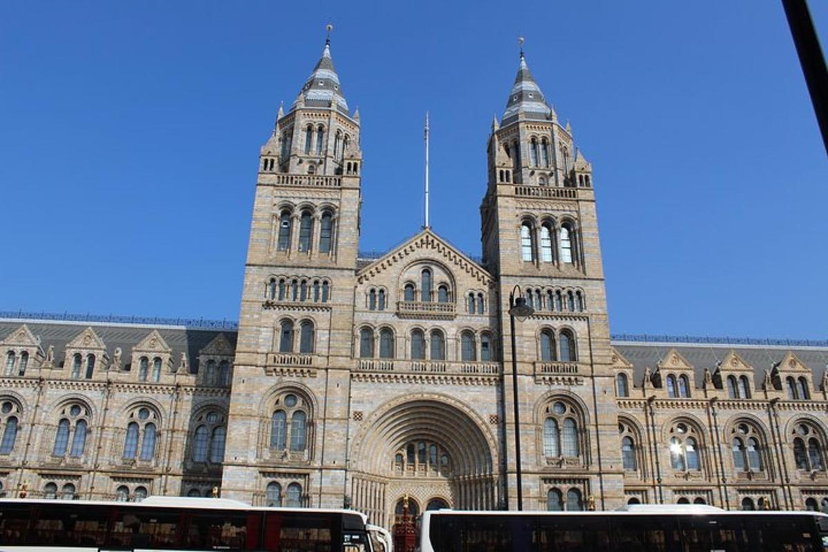 a large building with two towers and buses in front