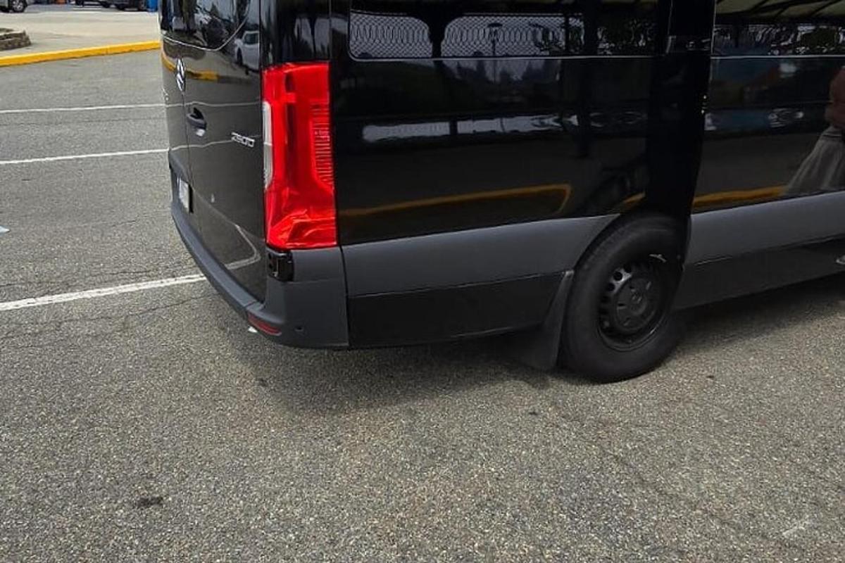a black van is parked in a parking lot