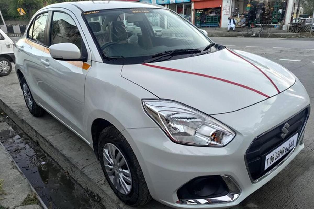 a white car parked on the side of a street