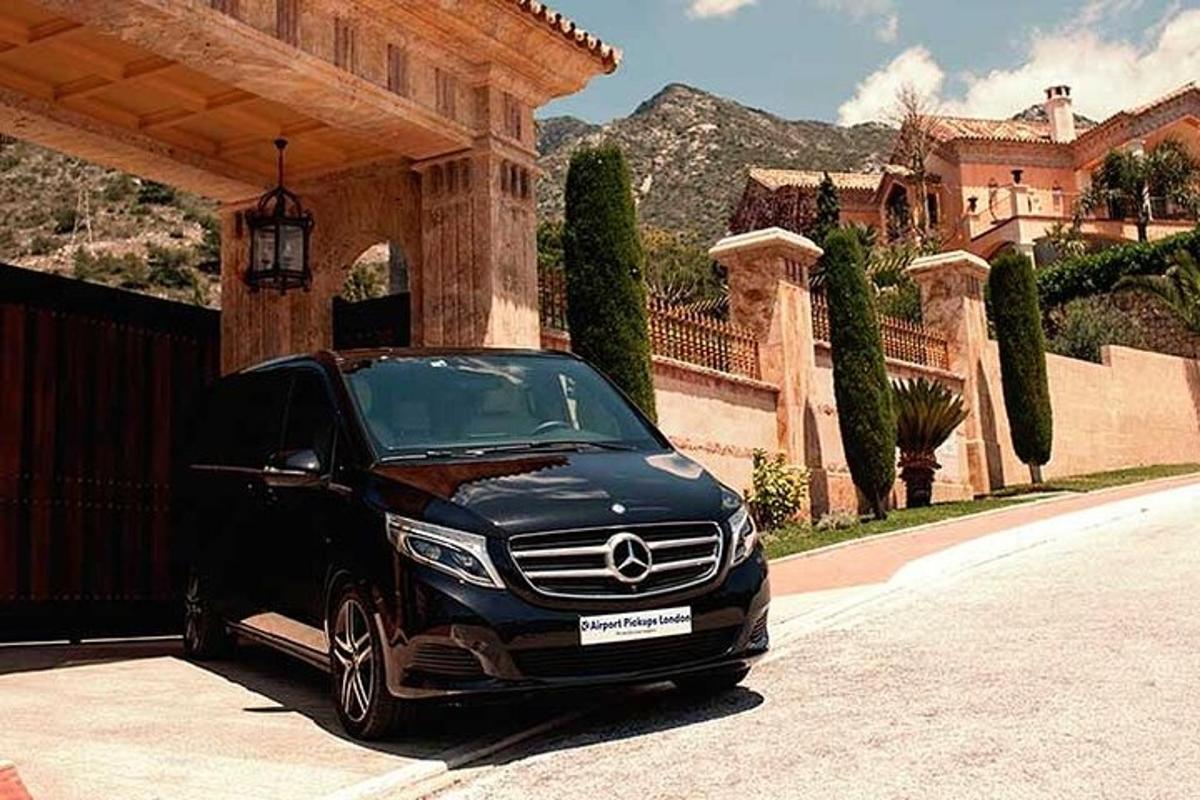 a black car parked in front of a house
