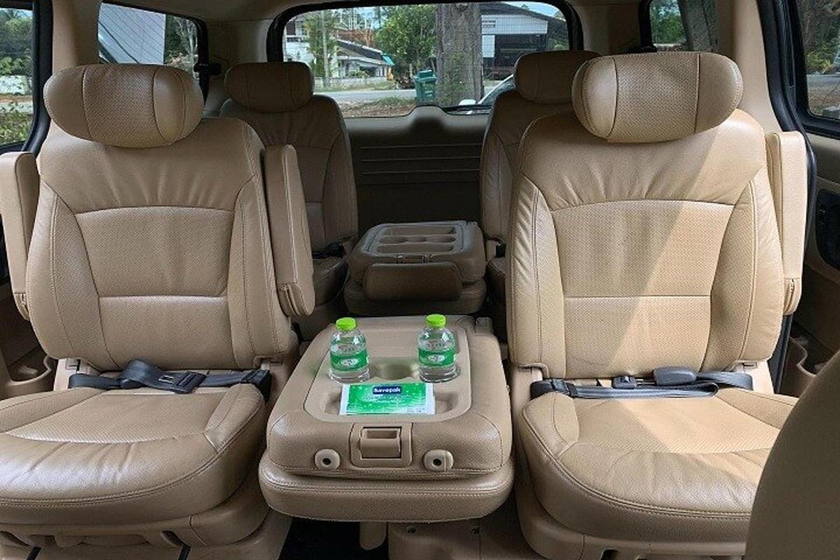 two seats in the back of a car with two bottles