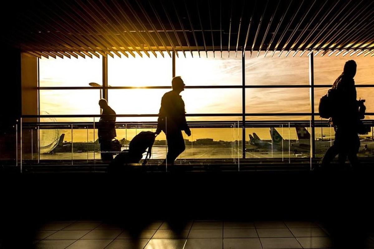 a group of people walking in an airport terminal