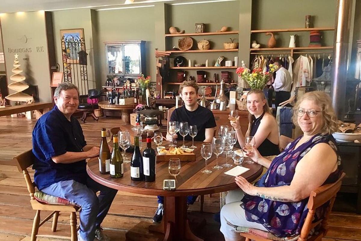 a group of people sitting around a table with wine glasses
