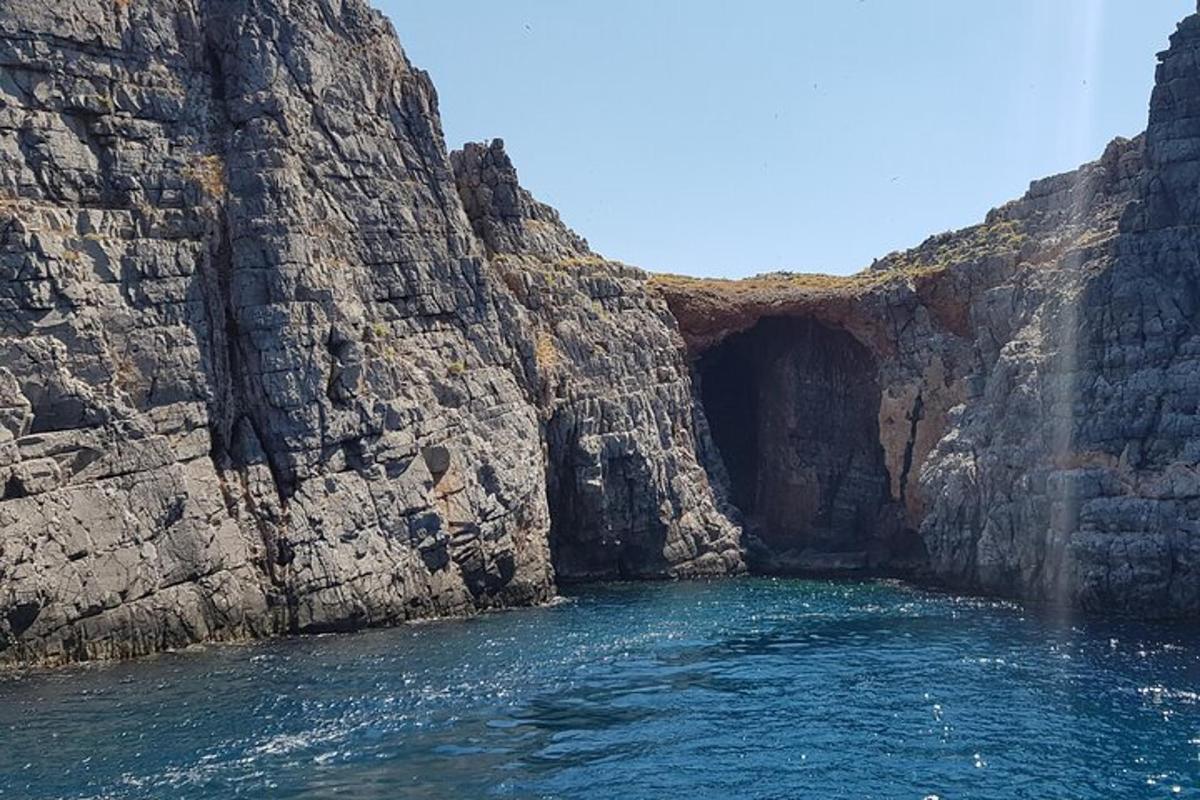 a cave in the side of a rocky cliff