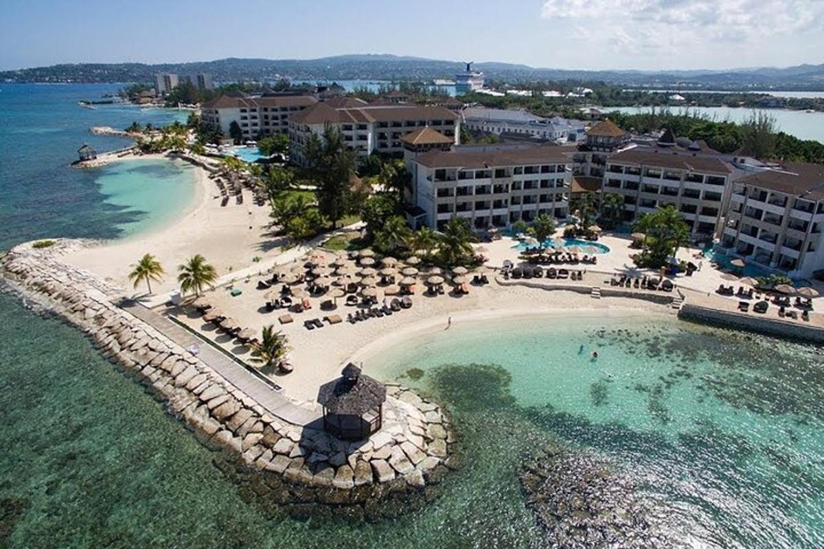 an aerial view of a resort with a beach