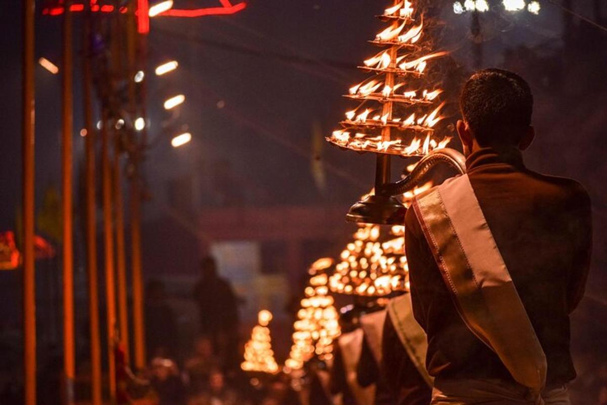 Un hombre de pie junto a un árbol de Navidad iluminado.