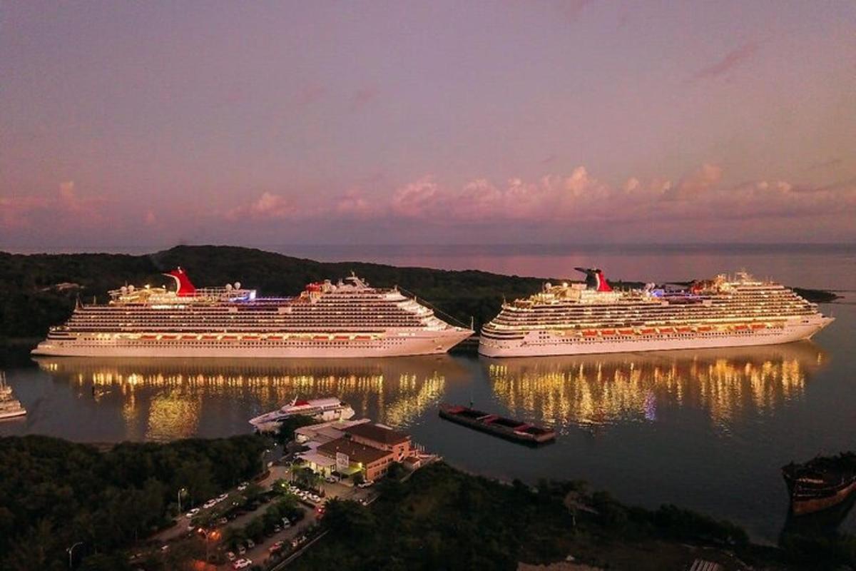 three cruise ships docked in the water at dusk