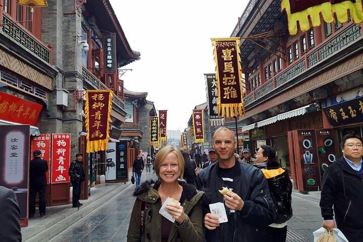 a man and a woman eating food on a street