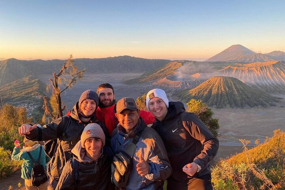 a group of people standing on top of a mountain