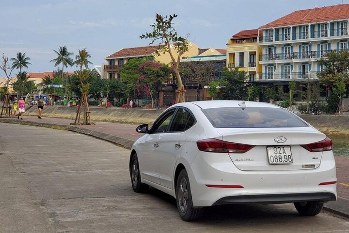a white car parked on the side of a street