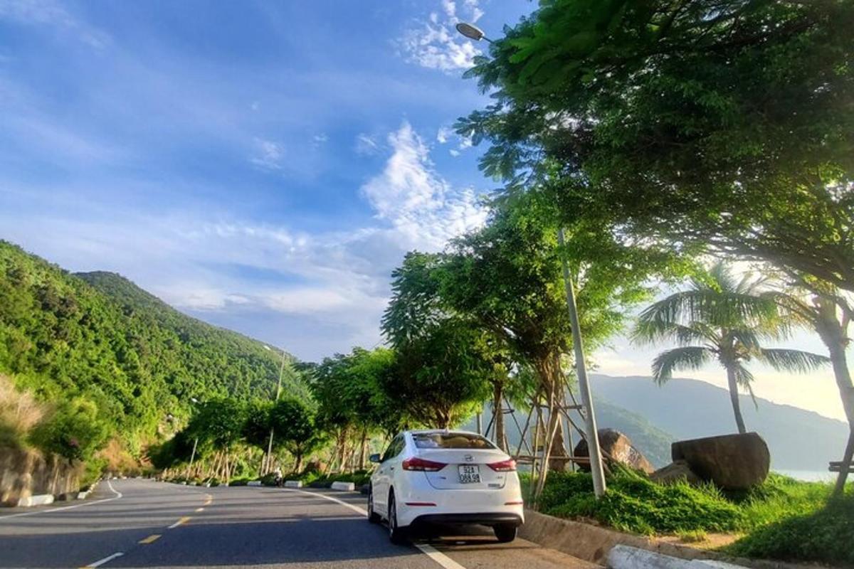 a white car parked on the side of a road