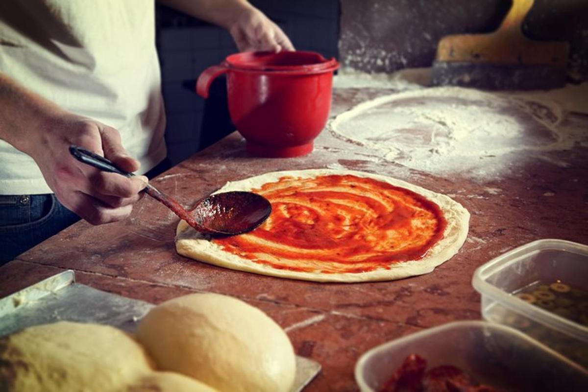 a person is making a pizza on a table