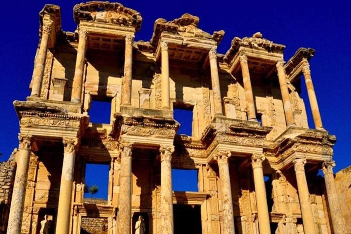 a tall building with pillars in front of a blue sky