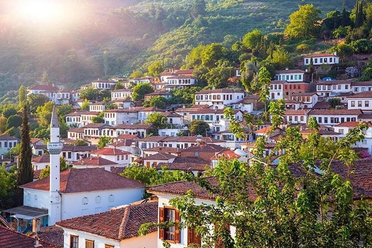 a village with a church and a hill with houses