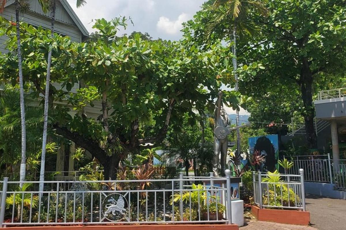 a white fence with trees in front of a building