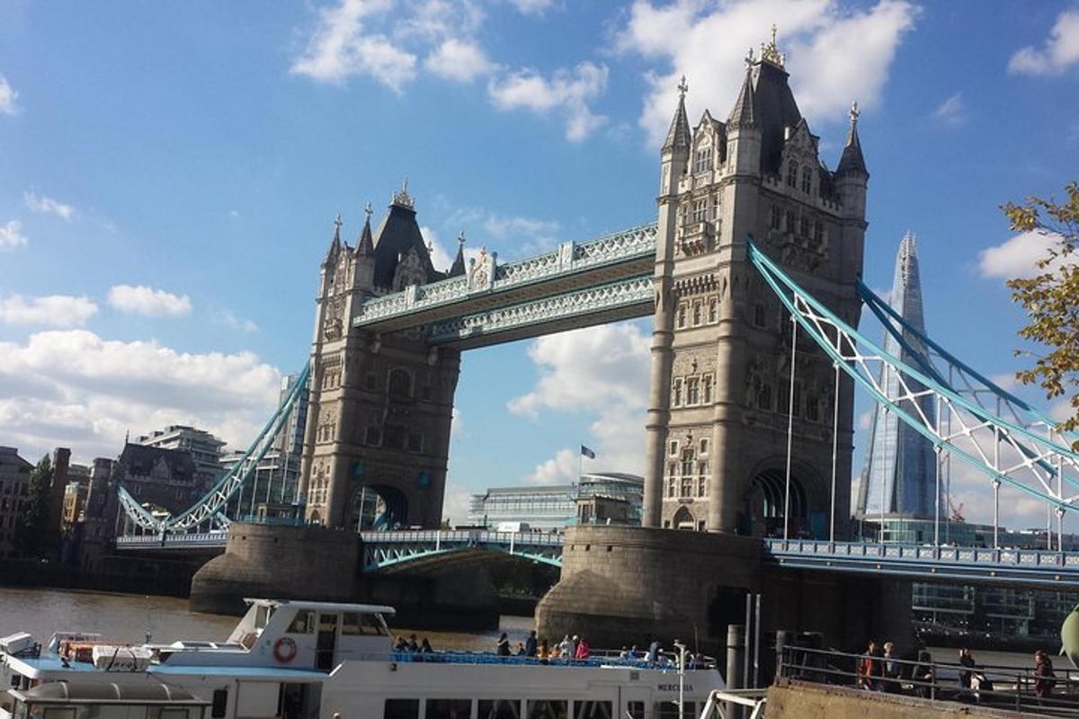 a suspension bridge with a boat in front of it