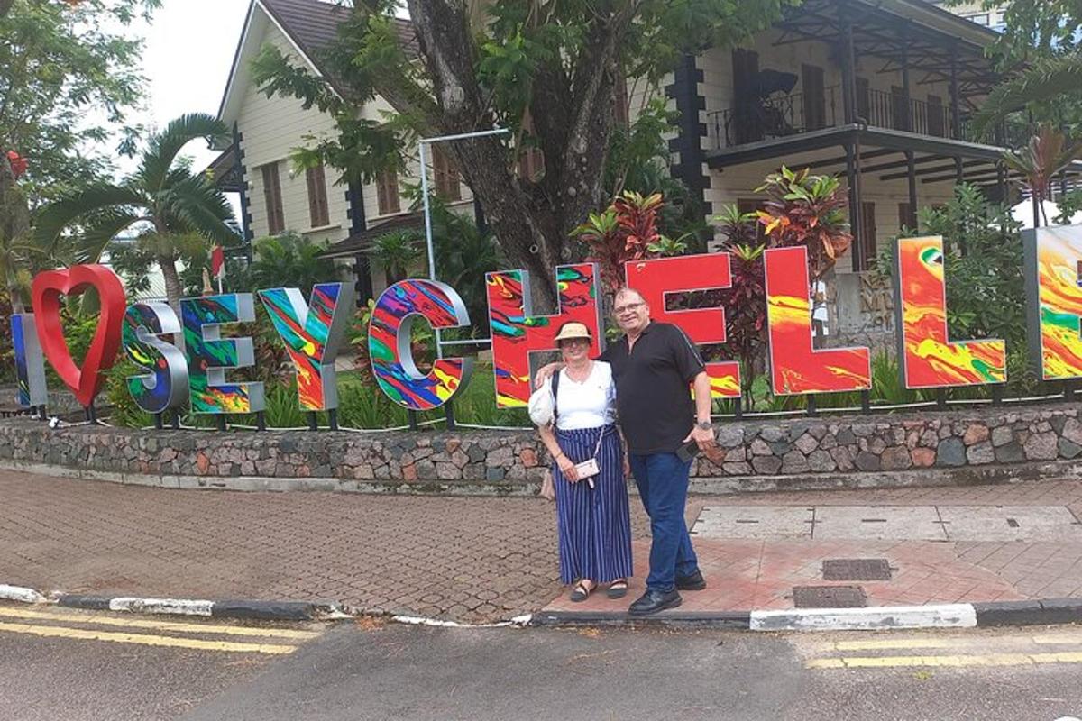 a man and a woman standing in front of a sign