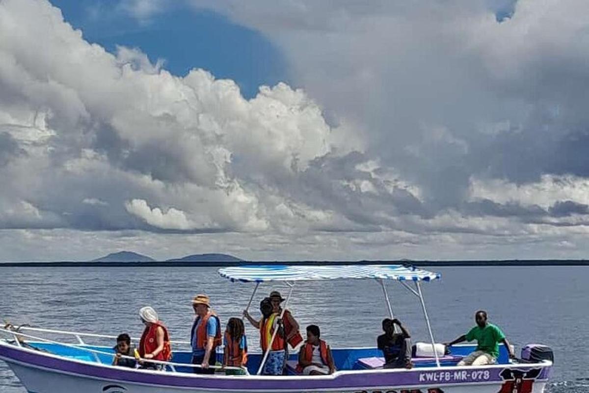 a group of people on a boat in the water