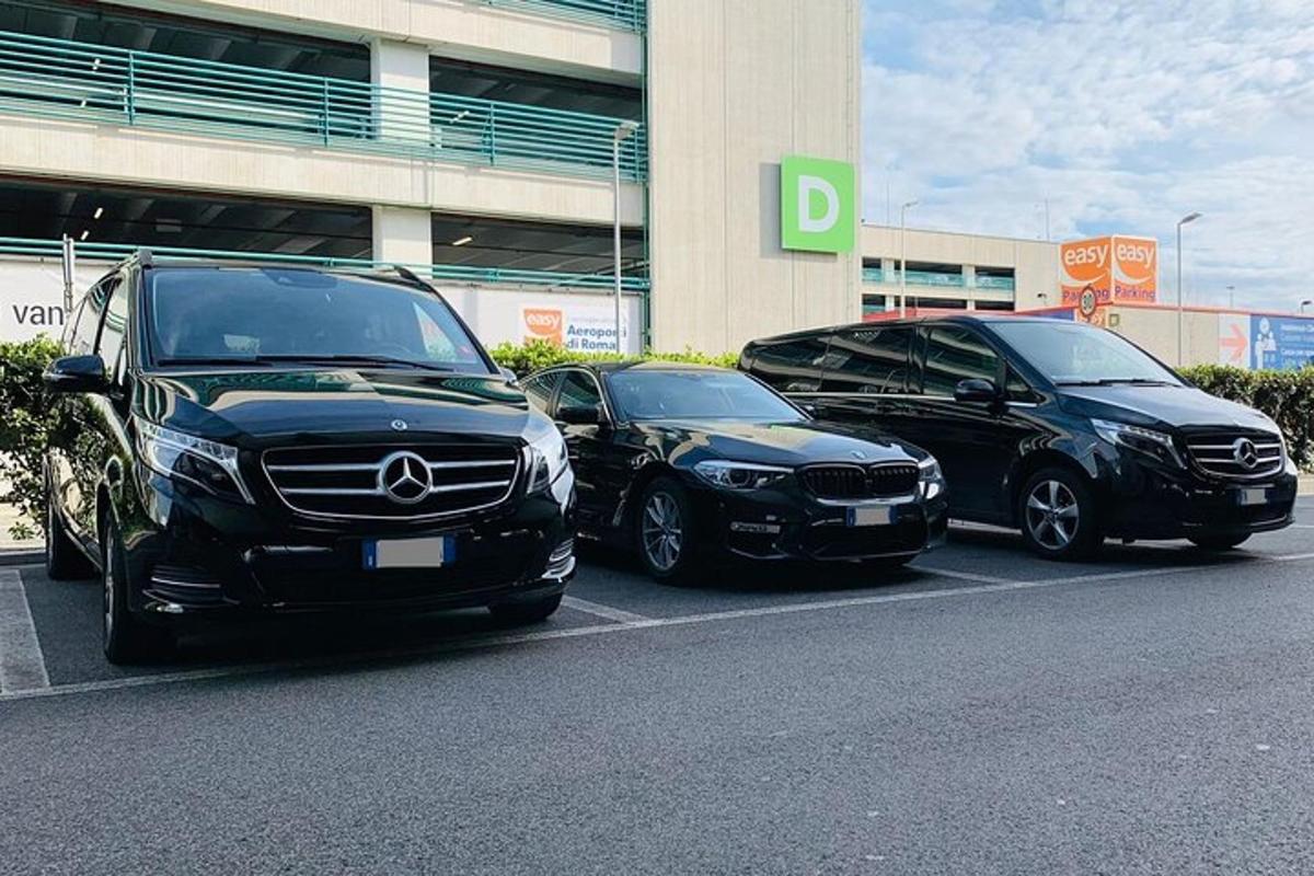 three cars parked in a parking lot in front of a building