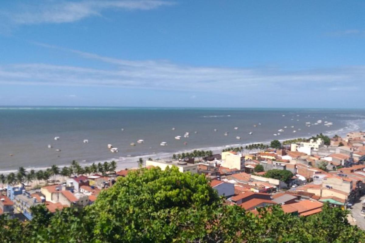 a view of a beach with a town and the ocean