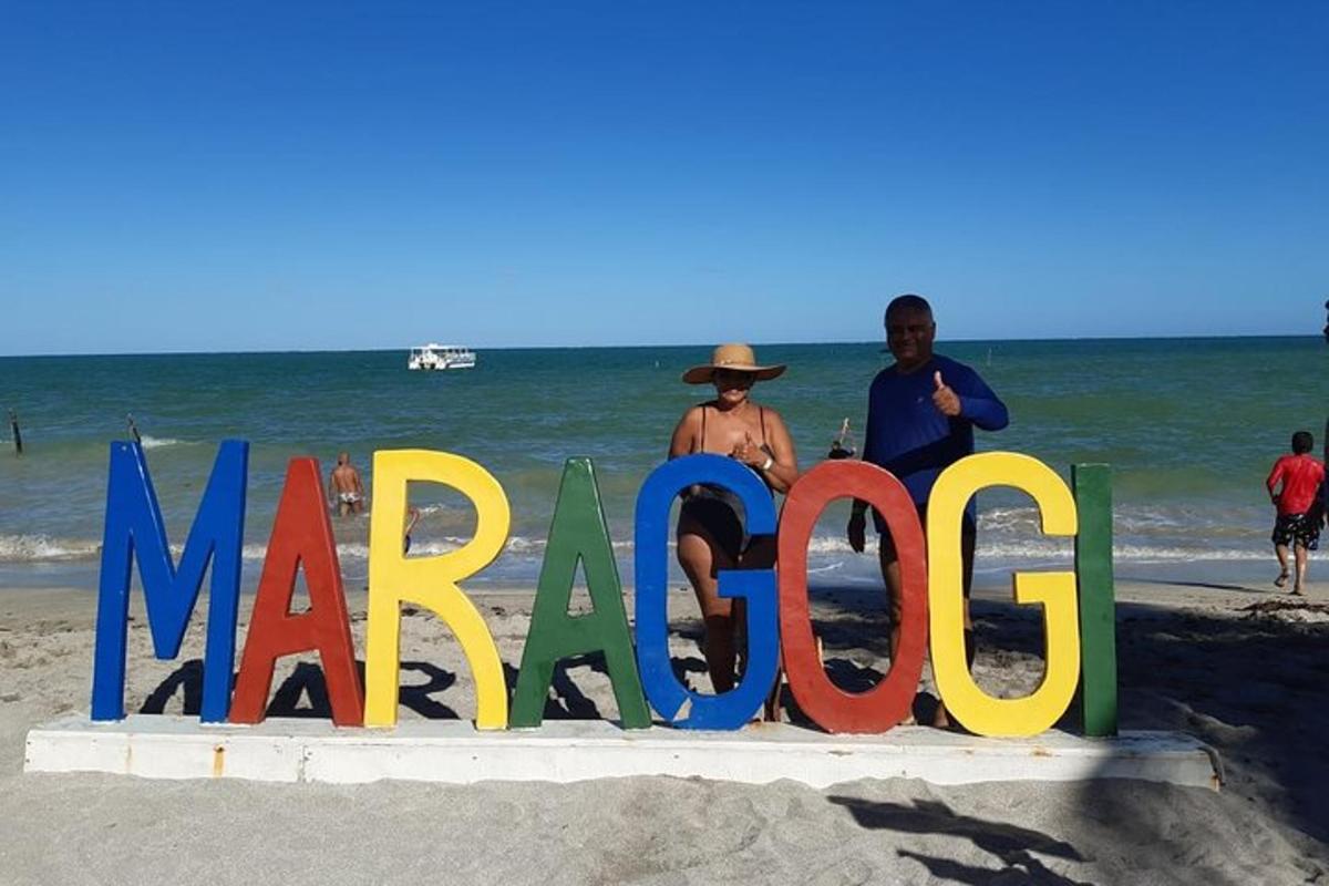 a group of people standing on the beach