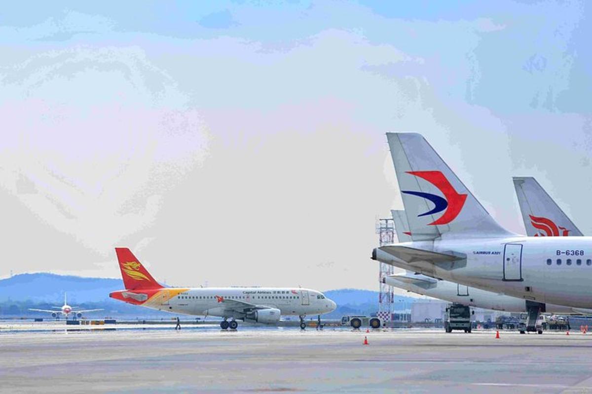 two airplanes parked on the runway at an airport