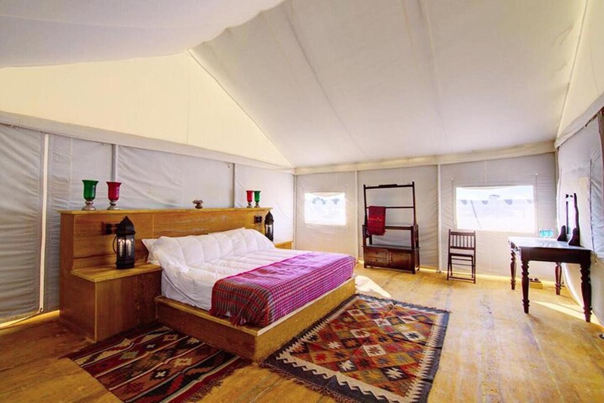 a bedroom with a bed in a room with a piano