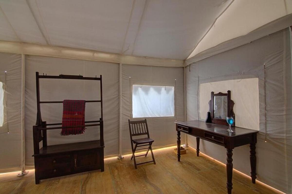 a room with a desk and a mirror and a chair