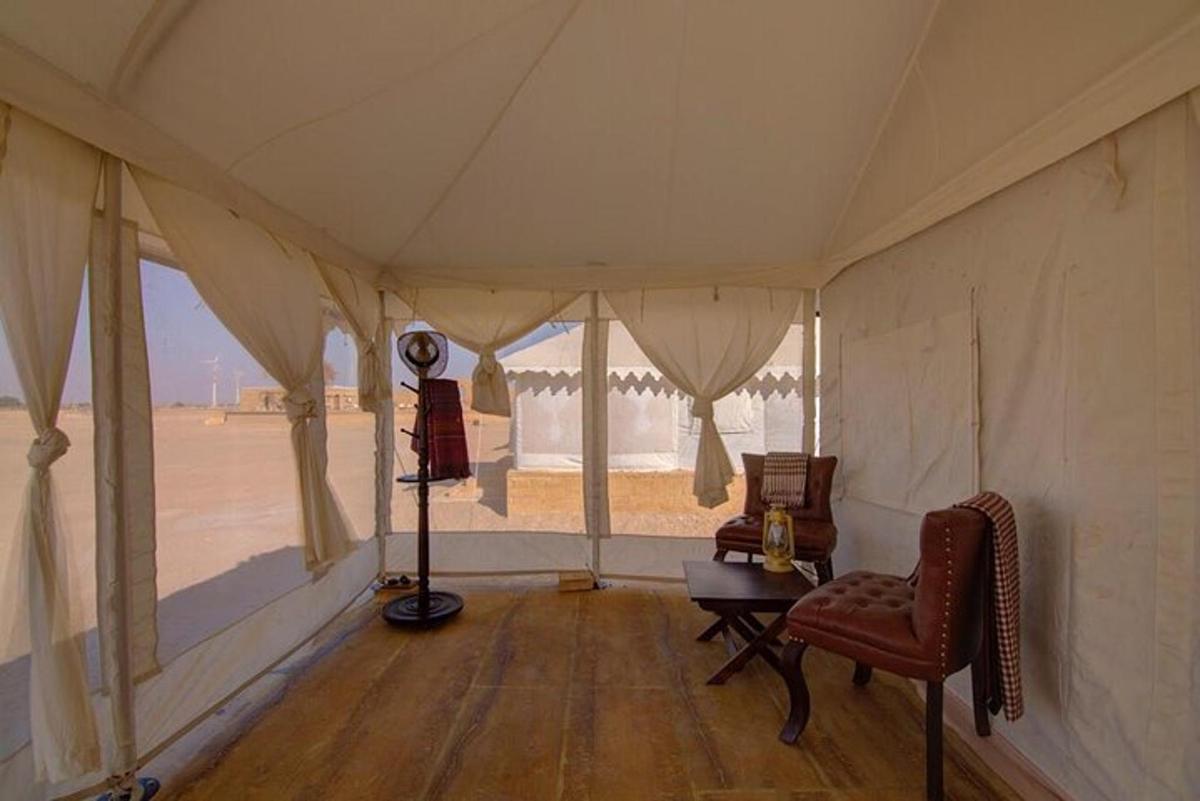 a room with a tent with a table and a chair