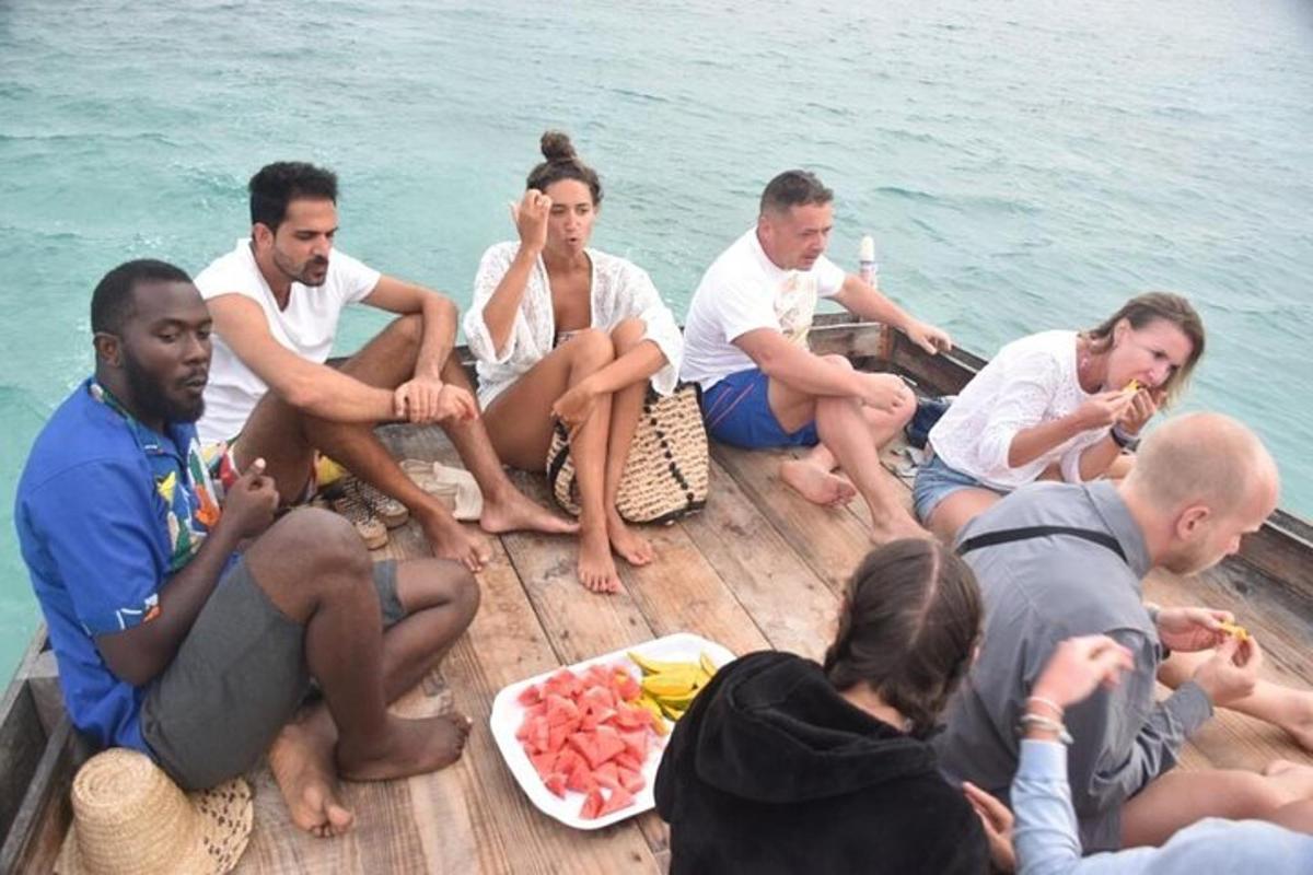 a group of people sitting on a boat eating food