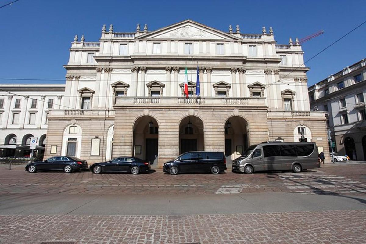 a large building with cars parked in front of it