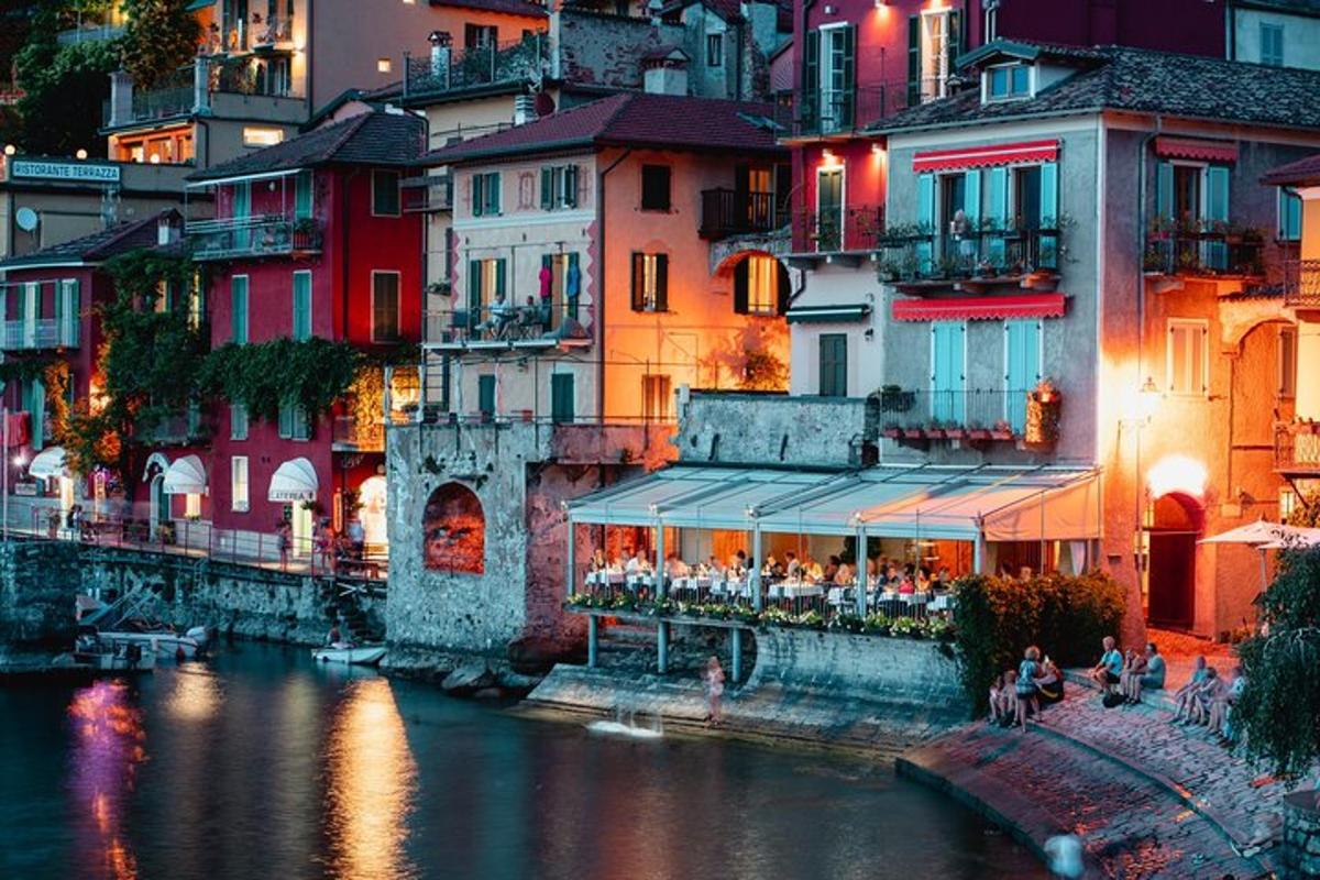 a group of buildings next to a river at night