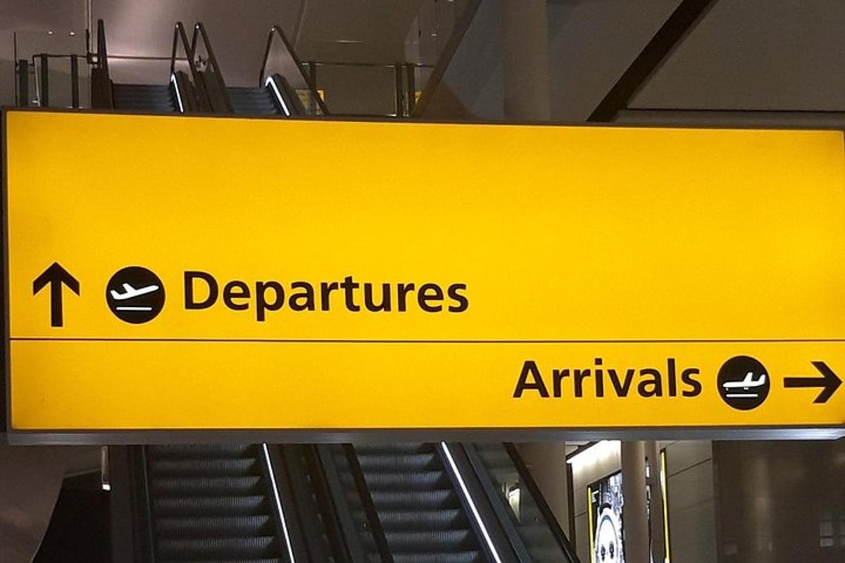 a yellow sign that says departures and arrivals