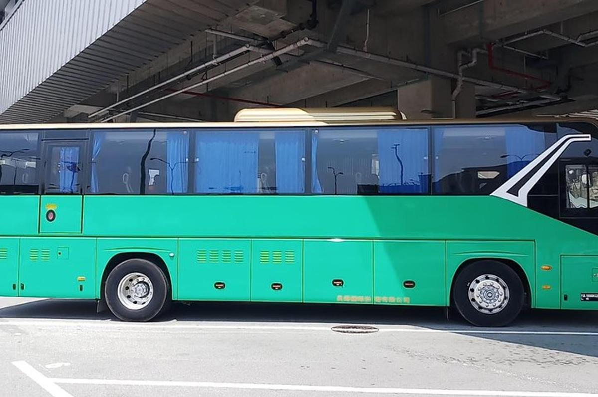 a green bus parked in a parking lot