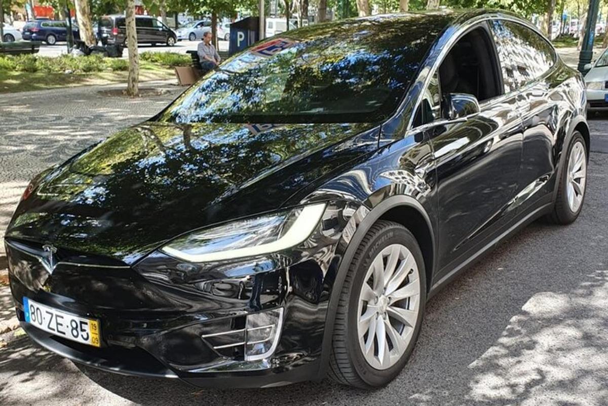 a black car parked on the side of a street
