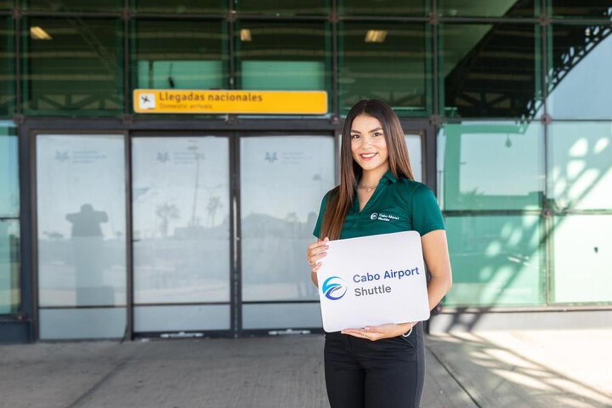 a woman holding a sign in front of a building